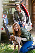 Woman with dog outside car