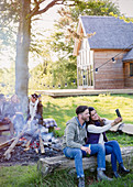 Couple taking selfie at campfire