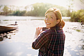Woman photographing lake