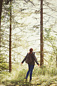 Woman with backpack in woods