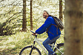 Smiling man riding mountain bike