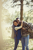 Smiling couple with backpacks hiking