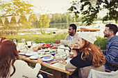 Friends enjoying lunch at lakeside