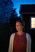 Woman looking away in dark backyard