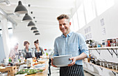 Smiling man in cooking class kitchen