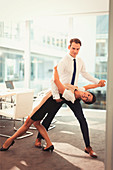 Businessman and businesswoman dancing tango