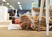 Businessman sleeping on office floor