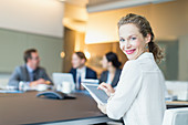 Businesswoman using digital tablet meeting