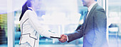 Businessman and businesswoman handshaking