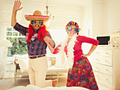 Portrait silly mature couple dancing in costumes