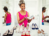Smiling mature woman looking at high heels