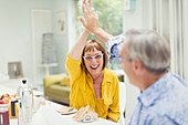 Enthusiastic mature couple high-fiving