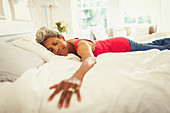 Serene mature woman laying on bed