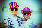 Couple wearing costume hats and sunglasses