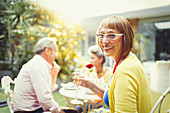 Portrait Woman drinking champagne at garden party