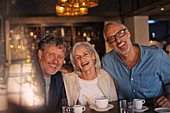Portrait laughing friends drinking coffee