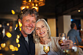 Portrait smiling senior couple toasting