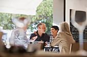 Affectionate couple dining with friends