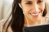 Close up smiling woman using digital tablet