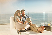 Couple relaxing using digital tablet