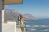 Couple looking at sunny ocean view