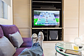 Man with feet up watching TV