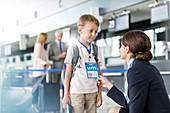 Flight attendant talking to child traveller