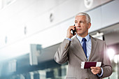 Businessman with passport and airplane ticket