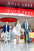 Business people leaving airport duty free shop