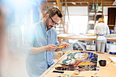 Stained glass artist working in studio