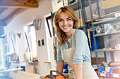 Portrait smiling artist in studio