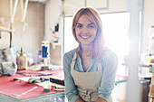 Portrait smiling artist in studio