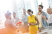 Business people celebrating birthday with cake