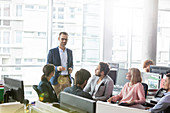Businessman leading meeting in office