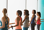 Smiling women exercising with resistance bands