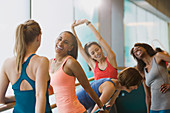 Smiling women talking and stretching