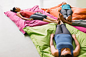 Women laying on cushions in yoga gym studio