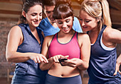 Young women and man in sports clothing texting