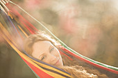 Portrait serene woman relaxing laying in hammock