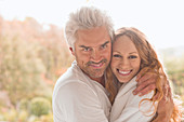 Portrait smiling couple hugging outdoors