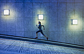 Female runner running ascending urban ramp
