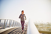 Female runner running at sunrise