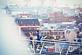 Runner couple running on urban footbridge