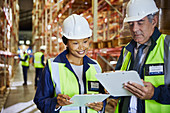 Manager and worker with clipboards meeting