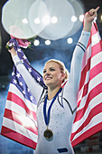 Female gymnast holding American flag