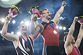 Gymnasts cheering on winners podium