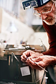 Focused male jeweller working in workshop