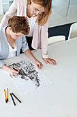 Female designers drawing sketch in conference room