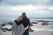 Couple hugging on winter beach
