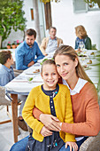 Portrait mother and daughter enjoying patio lunch